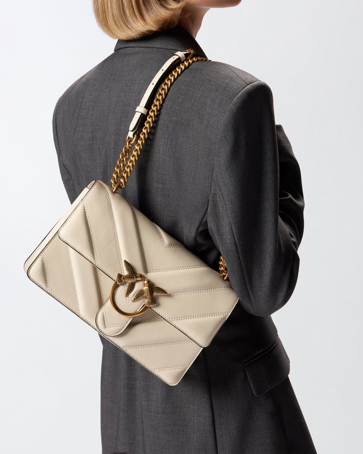 Medium Love Bag pebbled leather crossbody bag with V-shaped pattern and logo