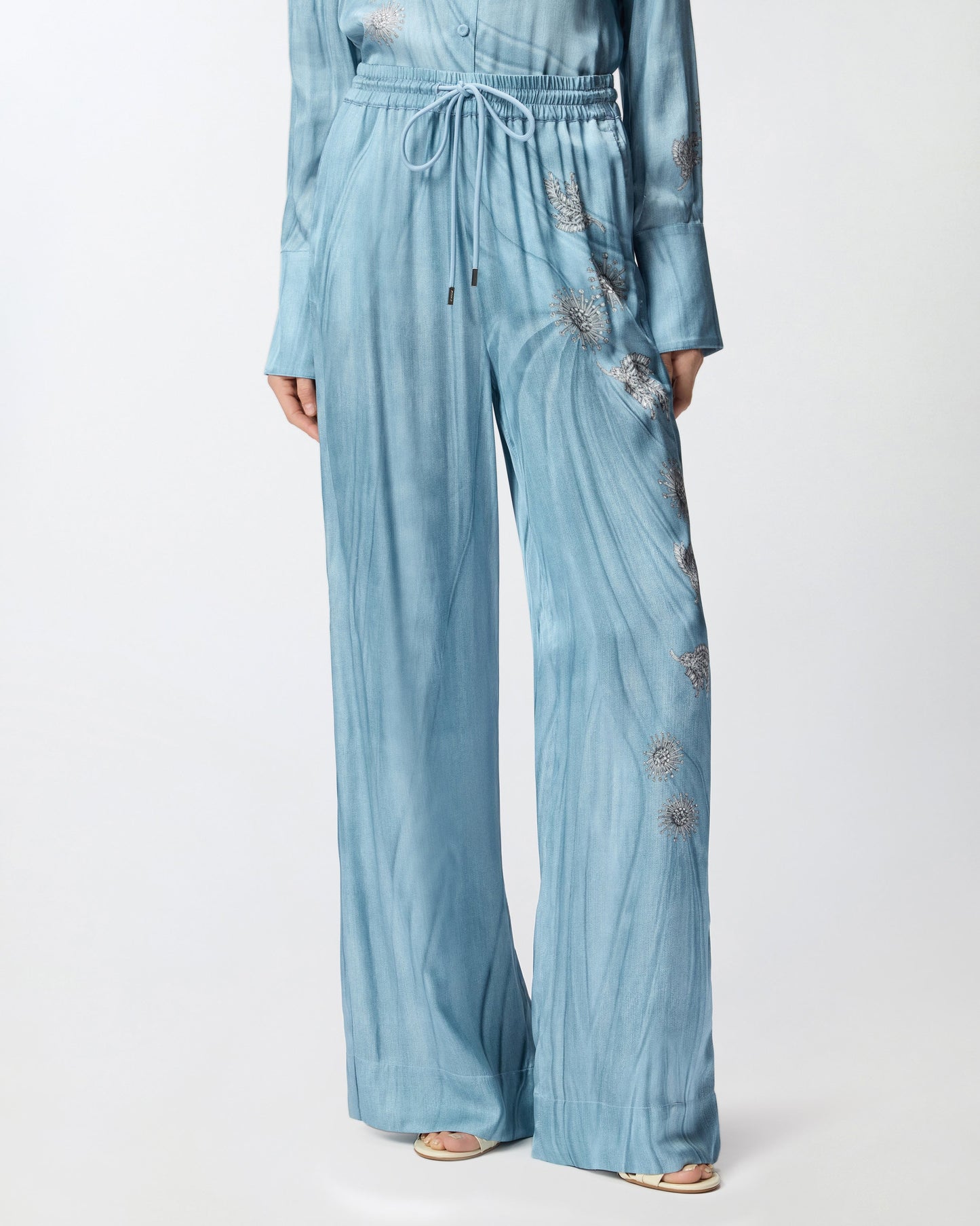 Fluid trousers with placed jewel print