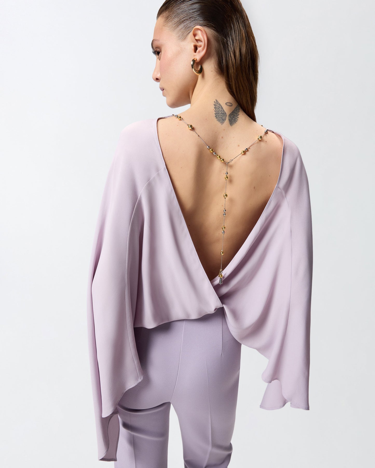 Long playsuit with exposed back and jewel necklace